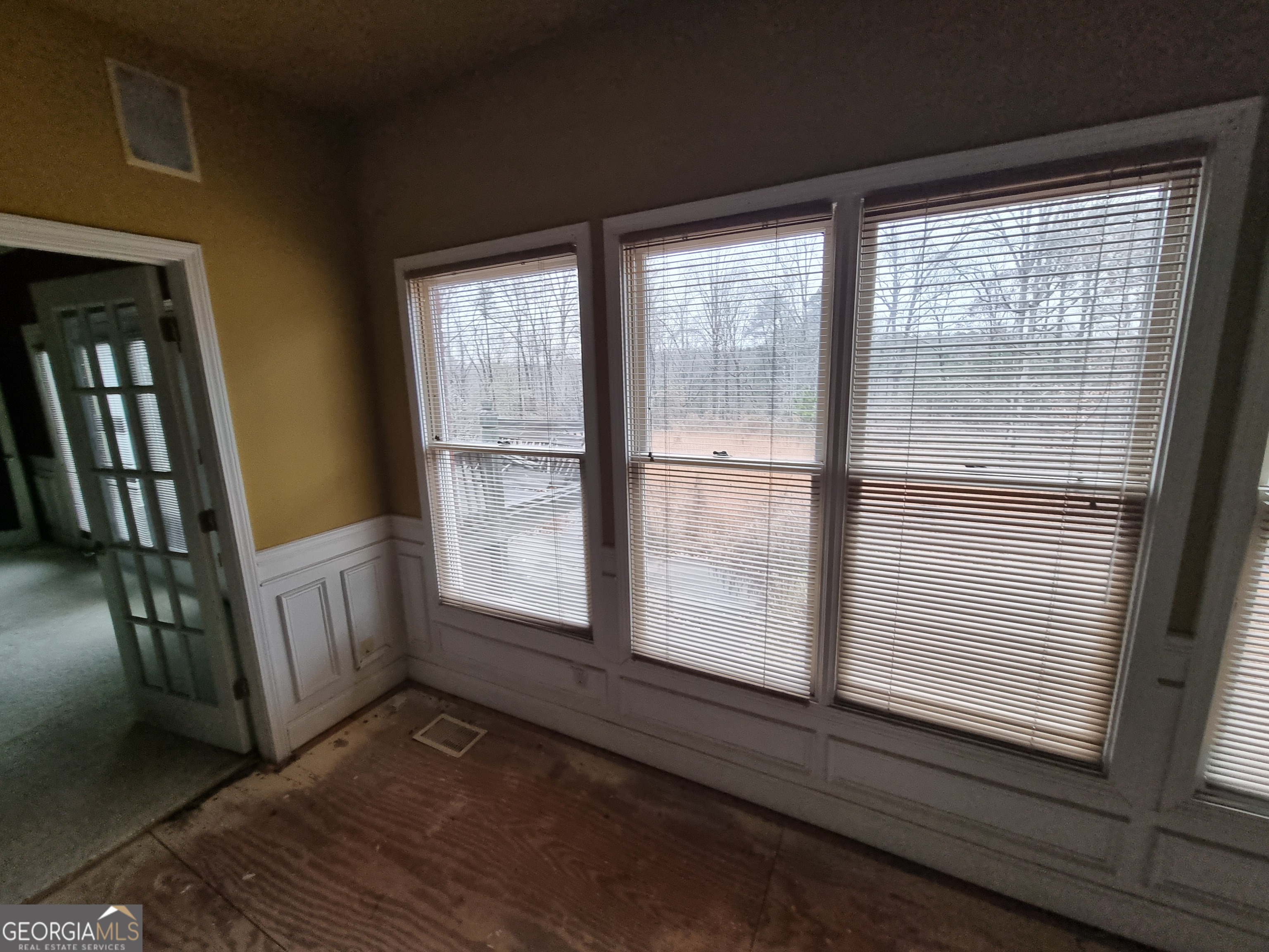 6235 Short Road Fairburn, GA 30213 - Photo 7 of 32 a view of an empty room with wooden floor and a window