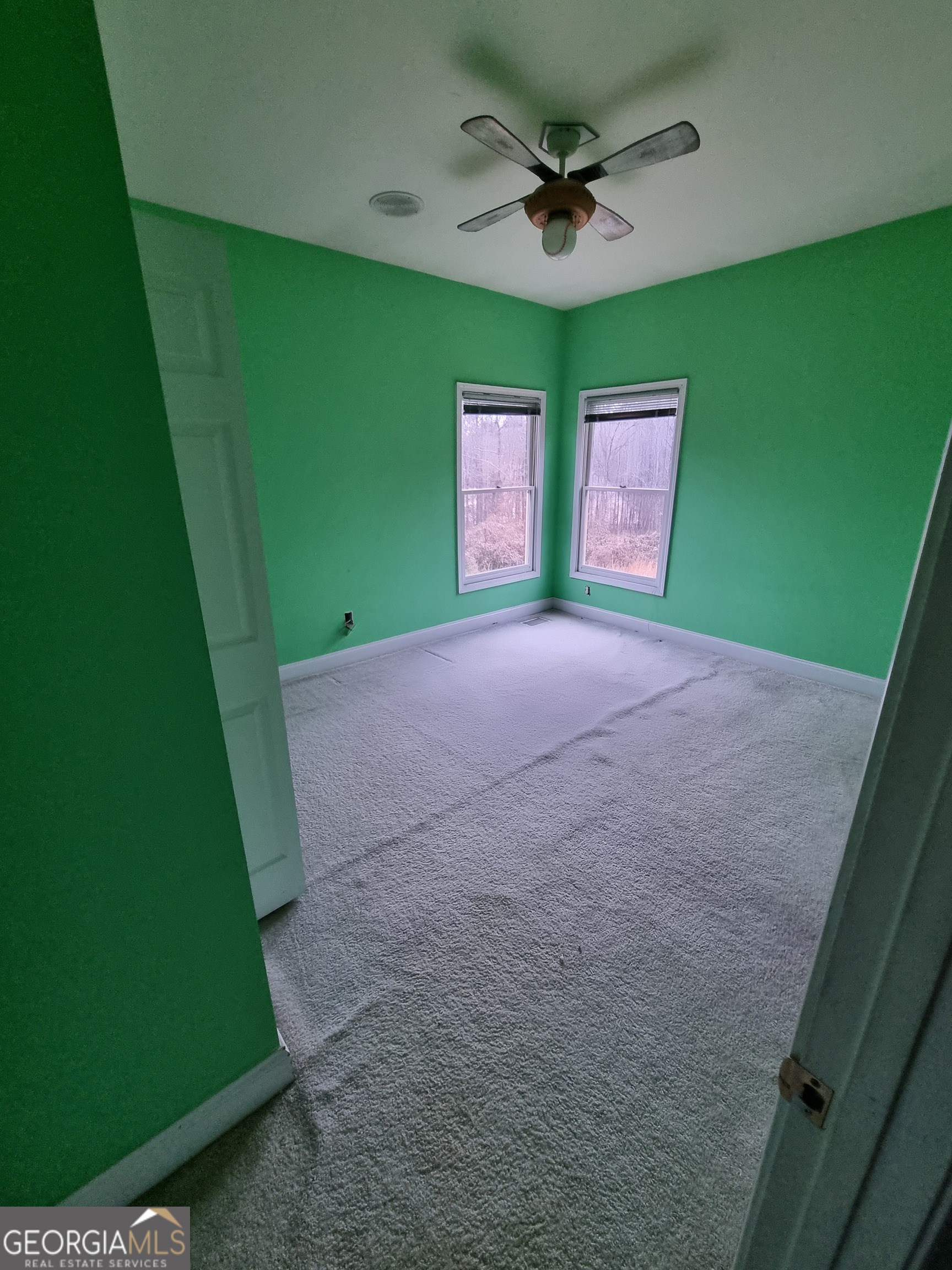 6235 Short Road Fairburn, GA 30213 - Photo 9 of 32 a view of a big room with a fireplace and a ceiling fan
