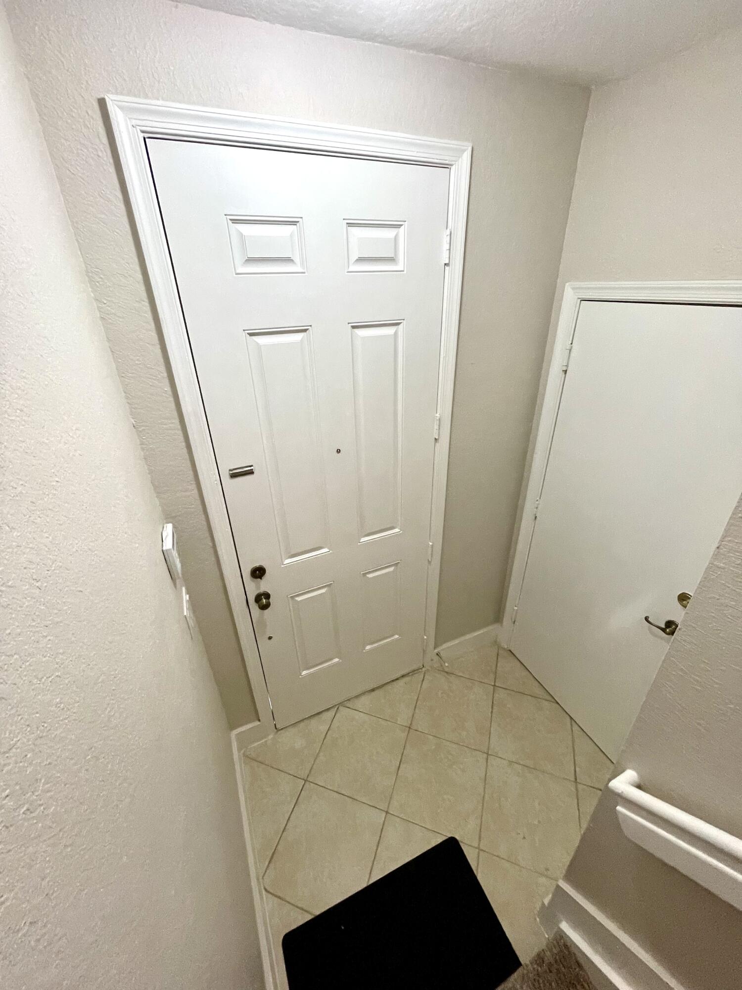 3043 Laurel Ridge Circle Riviera Beach, FL 33404 - Photo 5 of 35 ENTRY DOOR INSIDE HALL