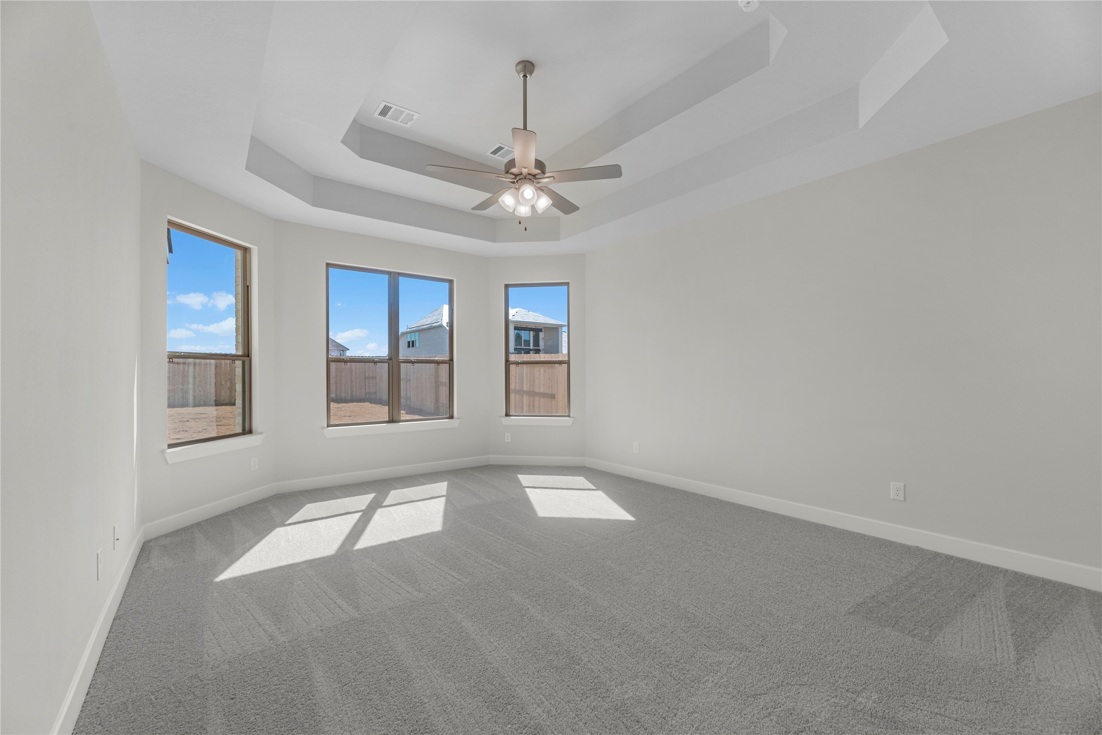 5023 Nesbit Path Rosenberg, TX 77471 - Photo 11 of 25 an empty room with chandelier fan and windows