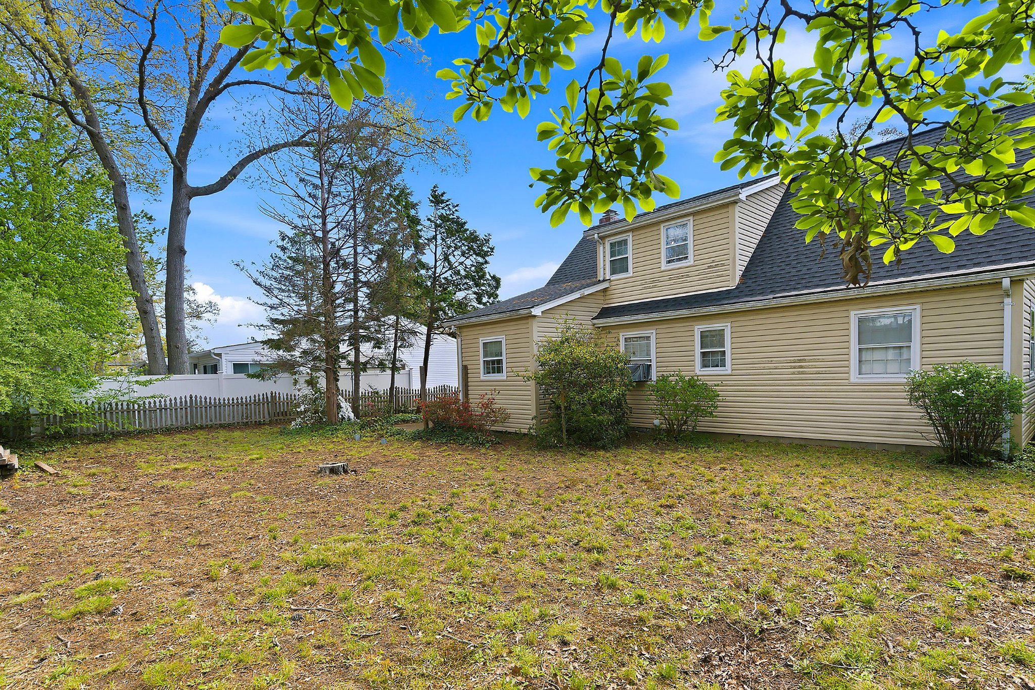 464 Newport Road Forked River, NJ 08731 - Photo 22 of 23 a view of a yard with plants and a large tree