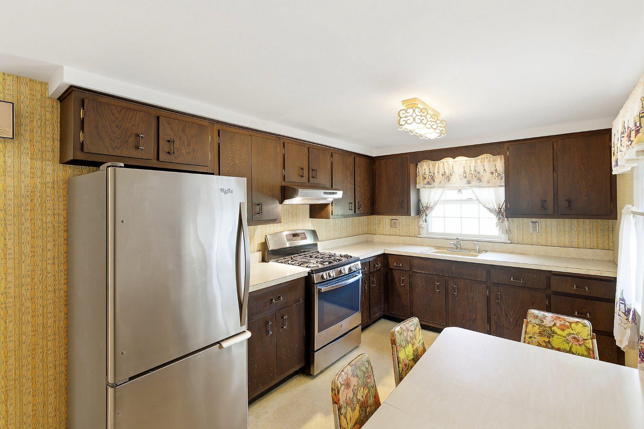 464 Newport Road Forked River, NJ 08731 - Photo 10 of 23 a kitchen with stainless steel appliances a refrigerator a sink a stove a dining table and chairs