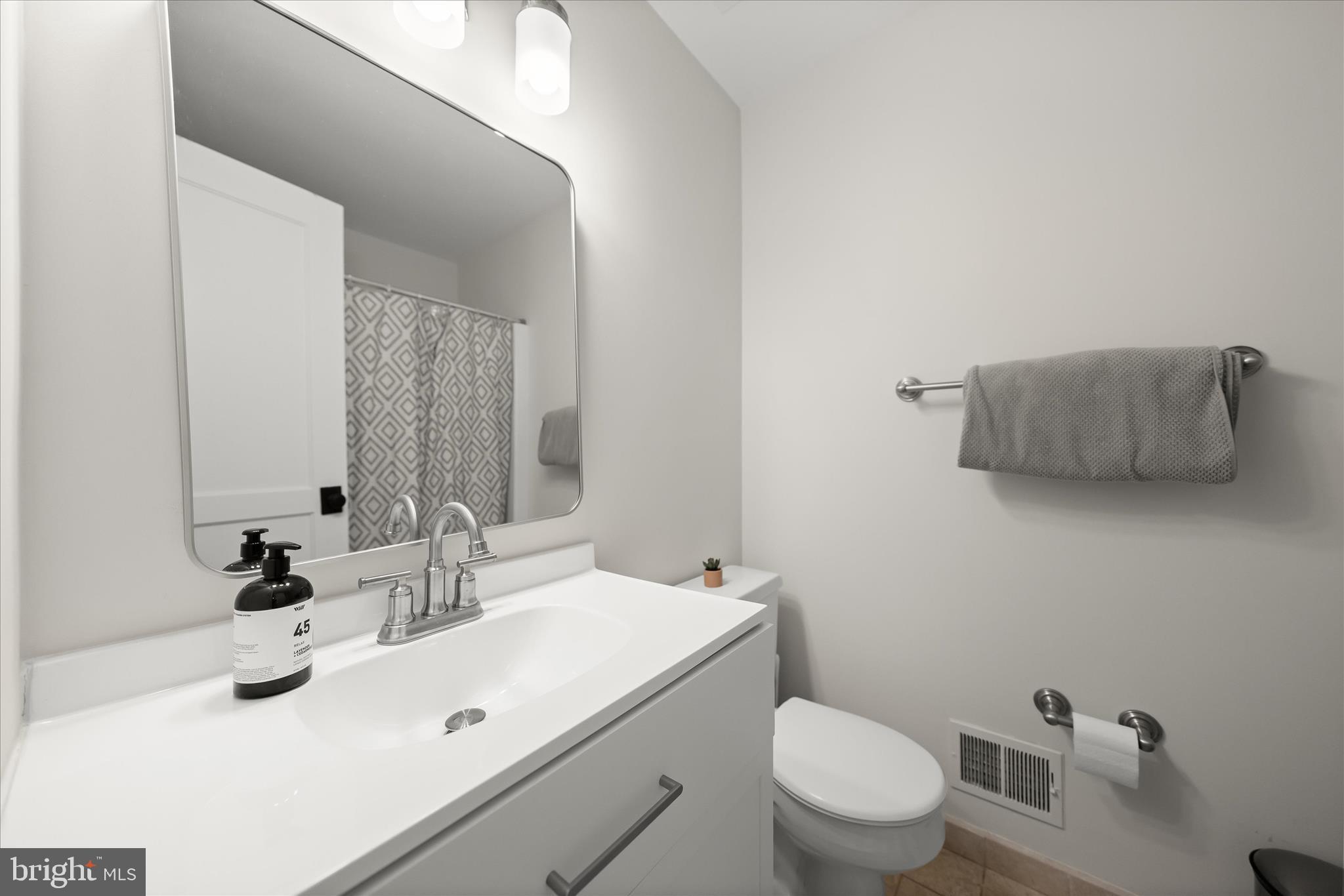 6366 11th Road North Arlington, VA 22205 - Photo 31 of 39 a bathroom with a sink toilet and mirror