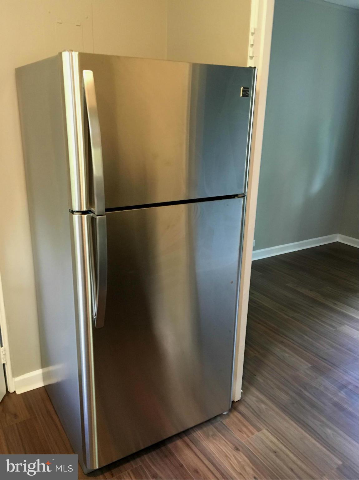 39 Ridge Road, Unit C Greenbelt, MD 20770 - Photo 12 of 22 a view of a refrigerator in kitchen and wooden floor