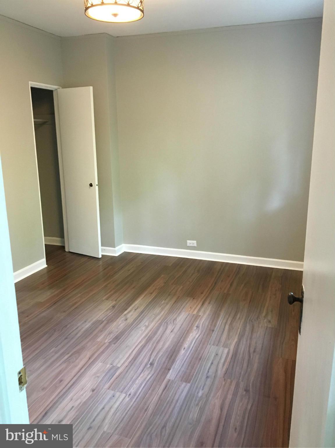39 Ridge Road, Unit C Greenbelt, MD 20770 - Photo 14 of 22 an empty room with wooden floor