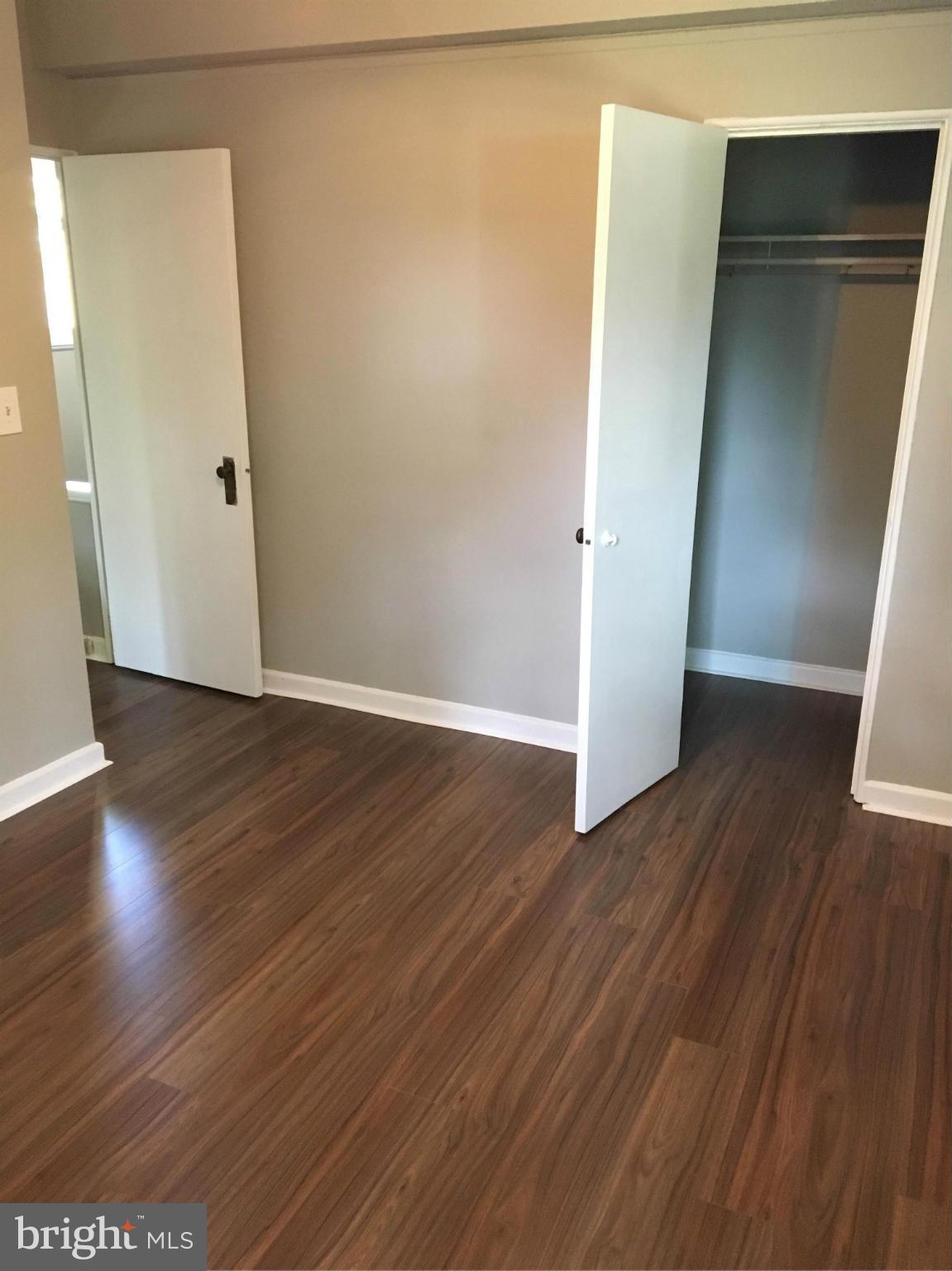 39 Ridge Road, Unit C Greenbelt, MD 20770 - Photo 18 of 22 an empty room with wooden floor and entrance