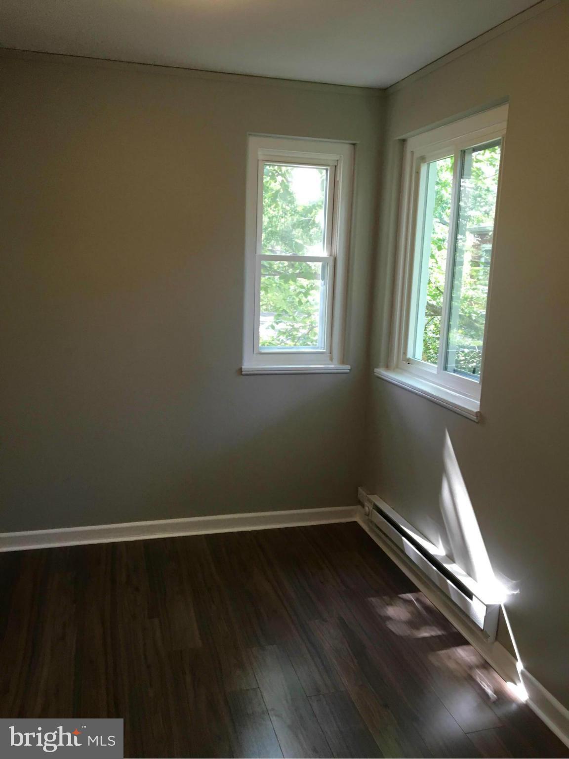39 Ridge Road, Unit C Greenbelt, MD 20770 - Photo 19 of 22 a view of a room with wooden floor and windows