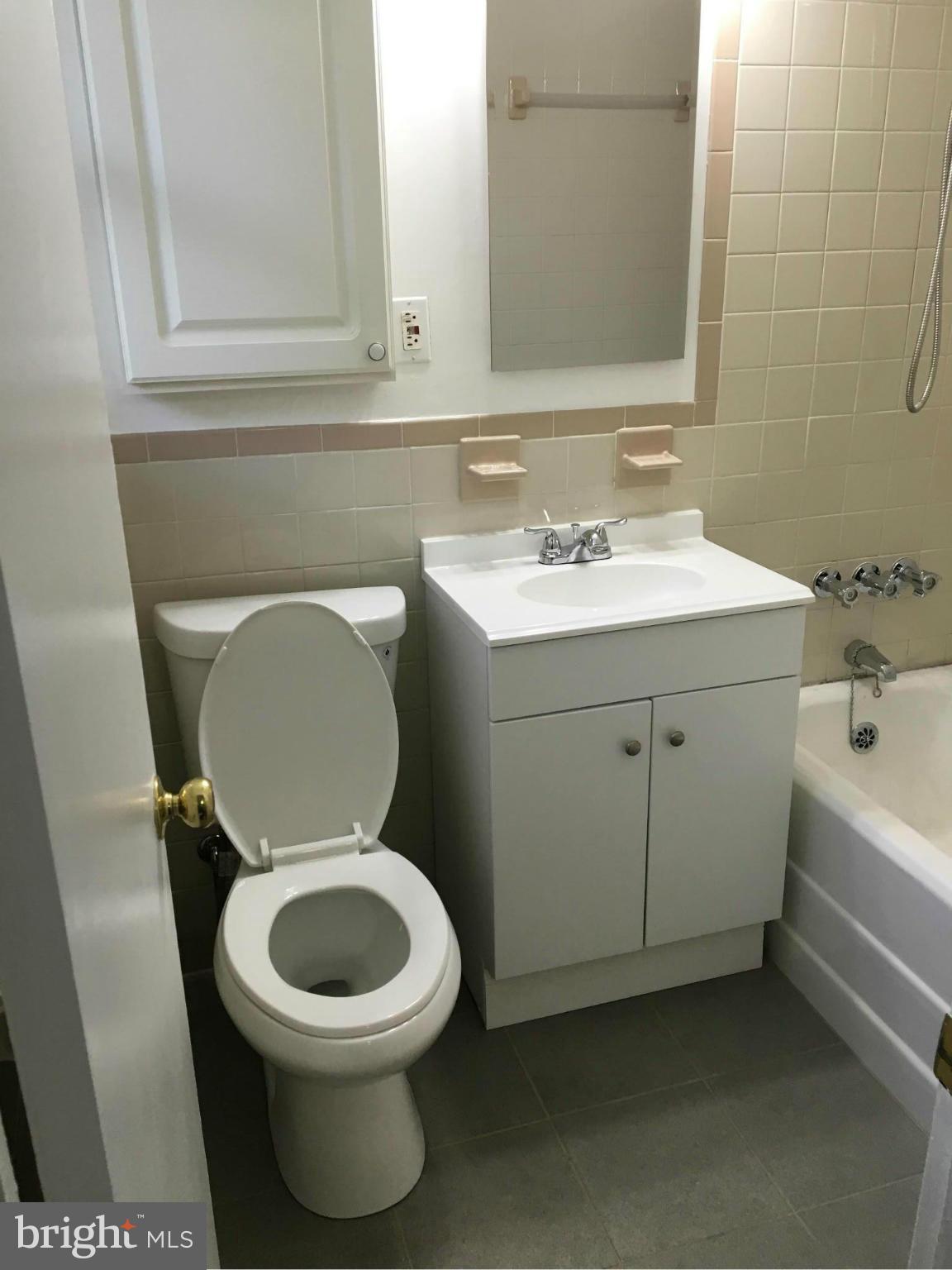 39 Ridge Road, Unit C Greenbelt, MD 20770 - Photo 20 of 22 a bathroom with a toilet sink and mirror