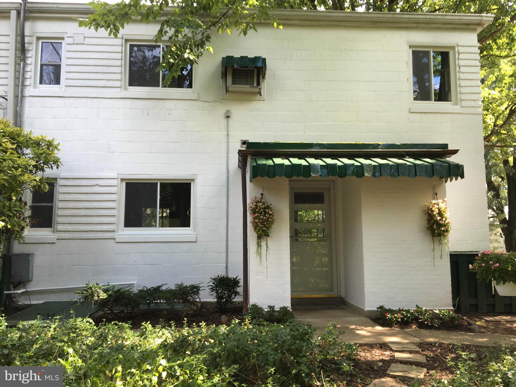39 Ridge Road, Unit C Greenbelt, MD 20770 - Photo 21 of 22 a front view of a house with a yard