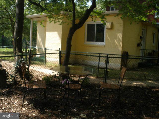 39 Ridge Road, Unit C Greenbelt, MD 20770 - Photo 22 of 22 a view of a house with backyard sitting area and garden
