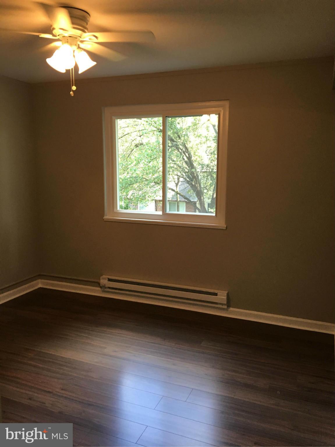 39 Ridge Road, Unit C Greenbelt, MD 20770 - Photo 5 of 22 a view of a room with wooden floor and a window