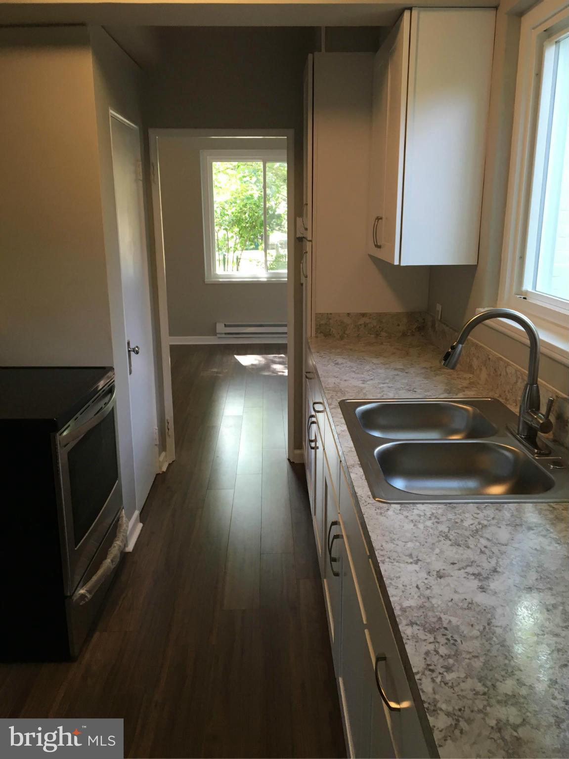 39 Ridge Road, Unit C Greenbelt, MD 20770 - Photo 6 of 22 a kitchen with granite countertop a stove and a sink
