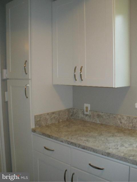 39 Ridge Road, Unit C Greenbelt, MD 20770 - Photo 7 of 22 a bathroom with a granite countertop white cabinets and a sink