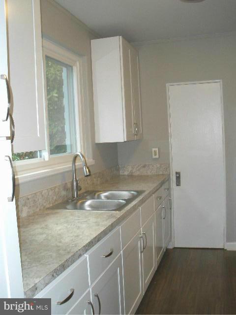39 Ridge Road, Unit C Greenbelt, MD 20770 - Photo 8 of 22 a kitchen with a sink stove and cabinets
