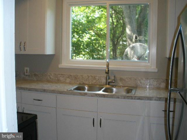39 Ridge Road, Unit C Greenbelt, MD 20770 - Photo 9 of 22 a kitchen with granite countertop a sink and a window