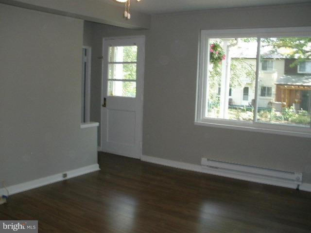 39 Ridge Road, Unit C Greenbelt, MD 20770 - Photo 10 of 22 a view of an empty room with wooden floor and a window