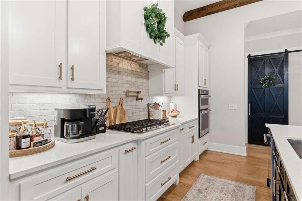 189 Waterview Circle Newnan, GA 30263 - Photo 16 of 83 a kitchen with stainless steel appliances a stove and white cabinets