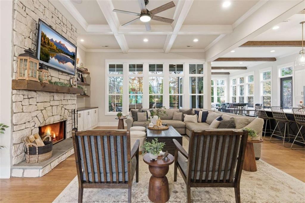 189 Waterview Circle Newnan, GA 30263 - Photo 8 of 83 a living room with furniture a fireplace and a floor to ceiling window