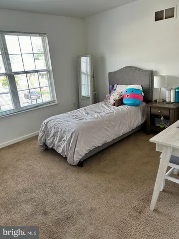 a bedroom with a bed and window
