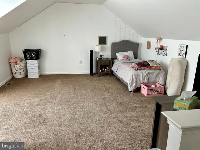 a bedroom with a bed and a chair