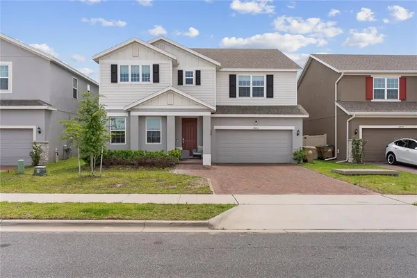 a front view of a house with a yard and garage