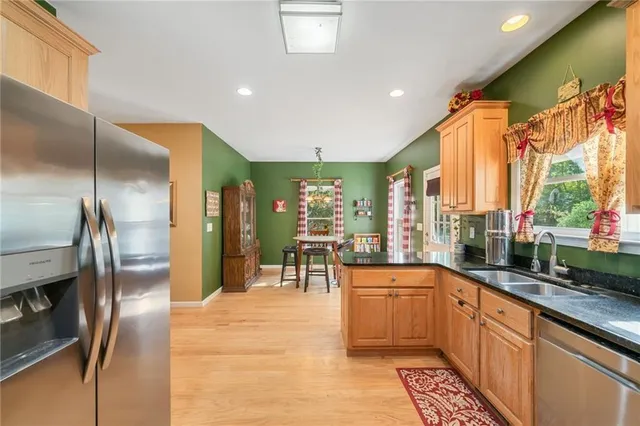 a large kitchen with a large window and stainless steel appliances