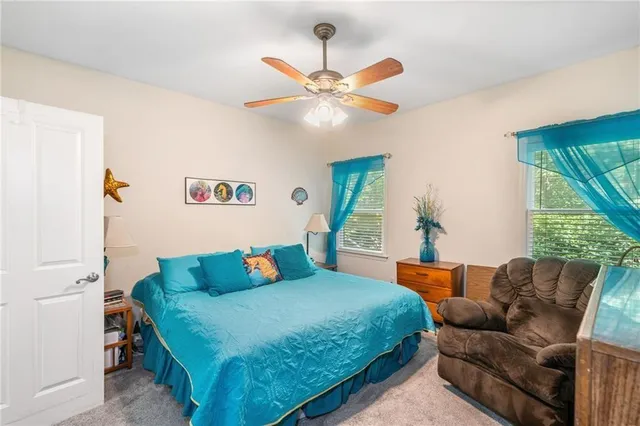 a bedroom with a bed couch and window