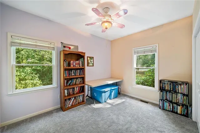 a view of an empty room with a window and a flat screen tv
