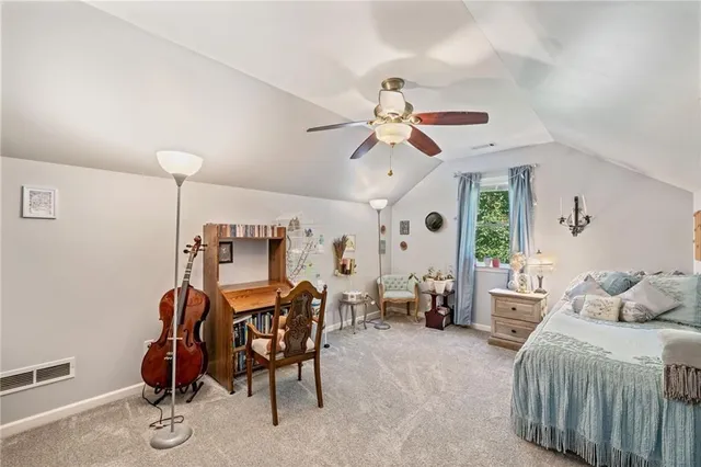 a view of a livingroom with furniture and a fan