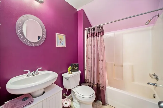 a bathroom with a sink mirror toilet and bathtub