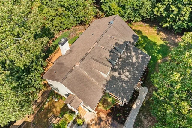 an aerial view of a house with a yard