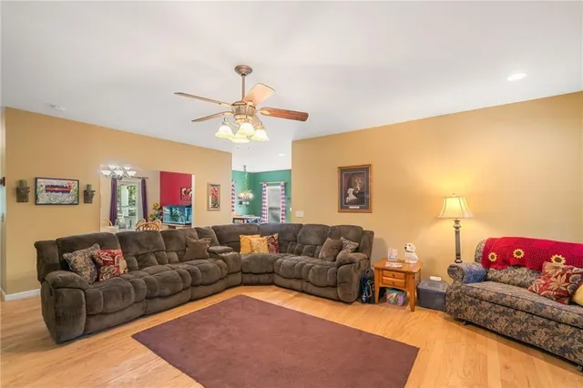 a living room with furniture and a chandelier
