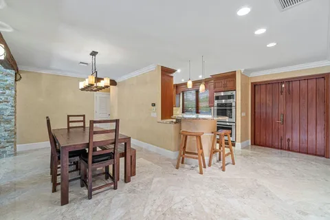 a view of a dining room with furniture and chandelier