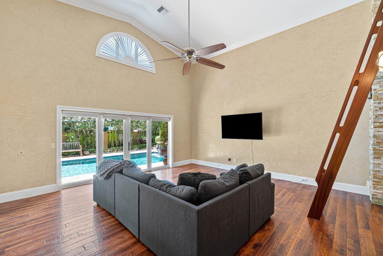 870 Northwest 7th Street Boca Raton, FL 33486 - Photo 16 of 37 a living room with furniture and a flat screen tv