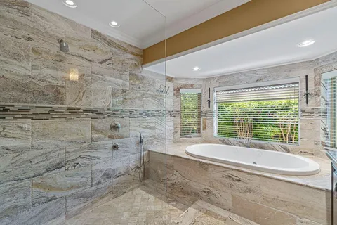 a spacious bathroom with a bathtub and next to a window