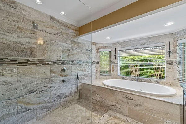 a spacious bathroom with a bathtub and next to a window