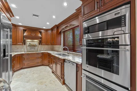 a kitchen with stainless steel appliances granite countertop a stove and a sink