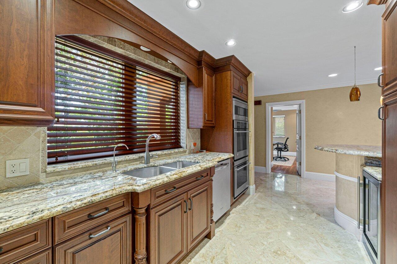 870 Northwest 7th Street Boca Raton, FL 33486 - Photo 10 of 37 a bathroom with a granite countertop sink and a bathtub