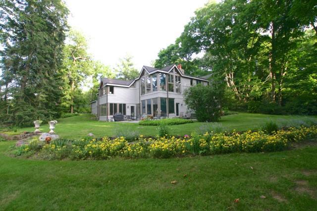 65 Fairfield Road Greenwich, CT 06830 - Photo 1 of 1 a front view of a house with a garden