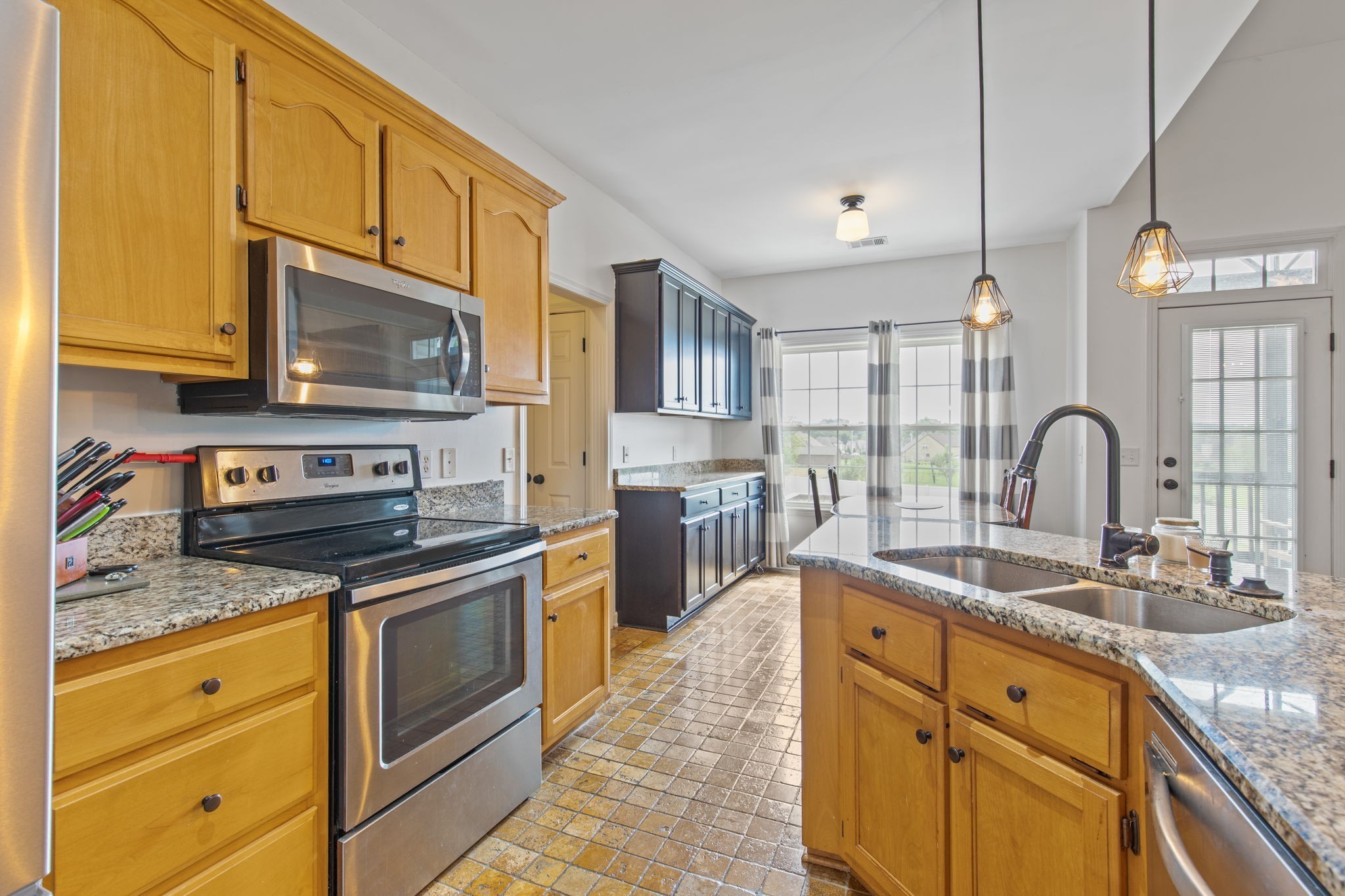1008 Rhett Place Lebanon, TN 37087 - Photo 8 of 35 a kitchen with stainless steel appliances granite countertop a sink stove and microwave