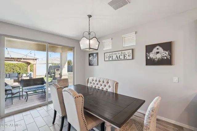 a living room with stainless steel appliances kitchen island furniture and a flat screen tv