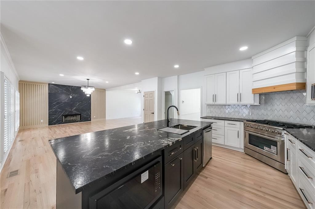 2130 Federal Road Roswell, GA 30075 - Photo 12 of 34 a large kitchen with stainless steel appliances granite countertop a stove a sink and a refrigerator