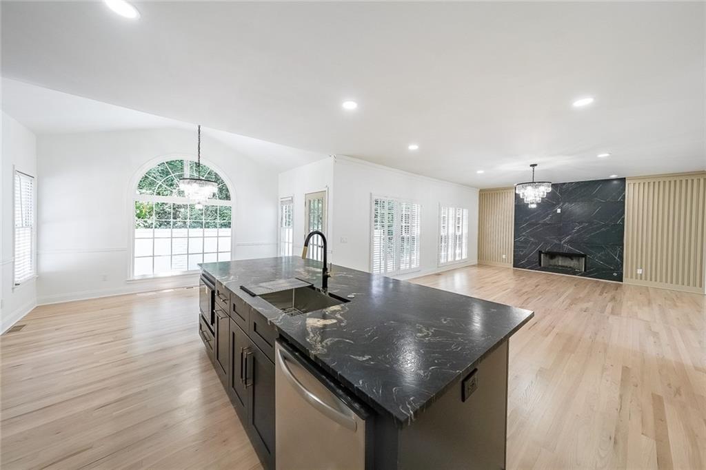 2130 Federal Road Roswell, GA 30075 - Photo 14 of 34 a kitchen with stainless steel appliances granite countertop a sink window and wooden floor