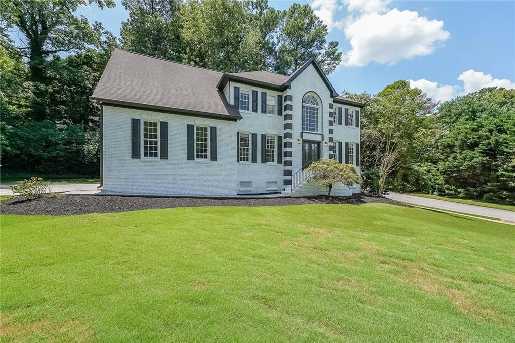 2130 Federal Road Roswell, GA 30075 - Photo 2 of 34 a front view of a house with garden