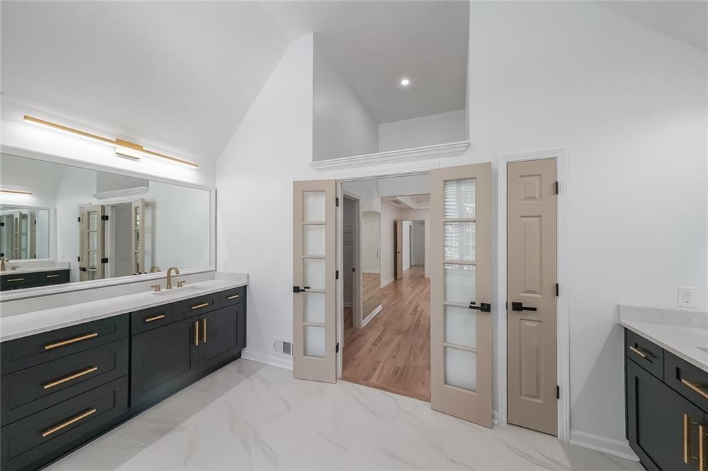 2130 Federal Road Roswell, GA 30075 - Photo 21 of 34 a spacious bathroom with a double vanity sink a mirror and a shower