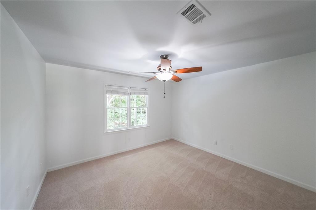 2130 Federal Road Roswell, GA 30075 - Photo 25 of 34 an empty room with a window and a ceiling fan