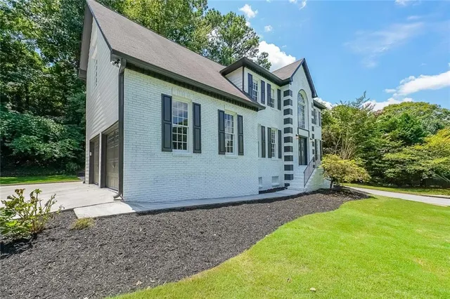 a front view of a house with garden