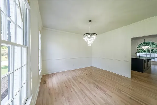 a view of a room with wooden floor and an entrance