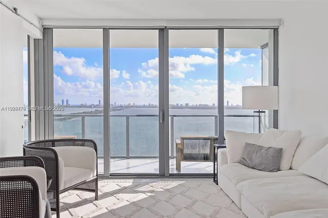 a living room with a large window and a table