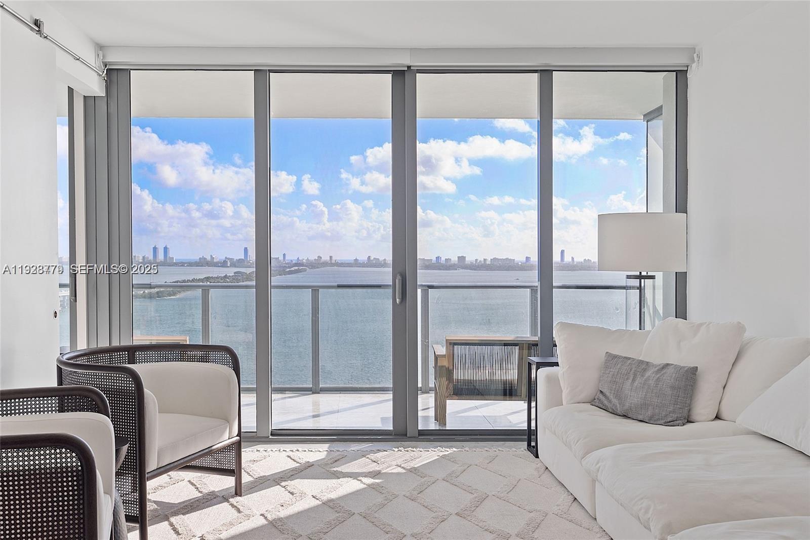 a living room with a large window and a table